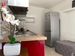 a kitchen with a sink and a refrigerator at Casa Renato in Grosseto