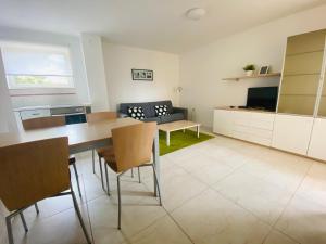 a kitchen and living room with a table and chairs at Apartments Lucija in Portorož