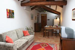 a living room with a couch and a dining room at B&B La Coperta Ricamata in Siena