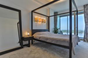 a bedroom with a large bed with a large mirror at Panoramic Sea Views in Klaipėda