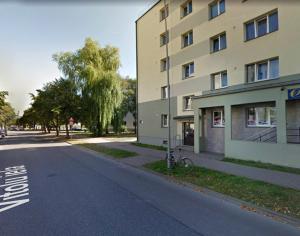 a bike parked on the side of a street next to a building at Sunshine Apartment in Liepāja