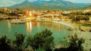 a view of a river with houses and a town at Villa Pefnos in Agios Nikolaos