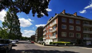 a building on the side of a street with cars parked at Au fil de l eau in Namur