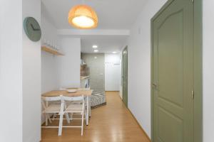 a kitchen and dining room with a table and chairs at Flat near the beach and center of Tossa de Mar "Sol" in Tossa de Mar
