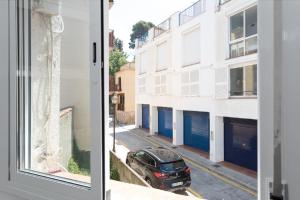 a car parked on a street next to a building at Flat near the beach and center of Tossa de Mar "Sol" in Tossa de Mar