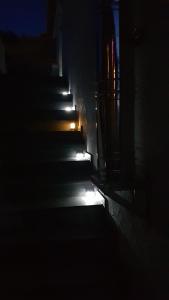 a stairway in the dark with lights on it at Die kleine Karthause in Konz