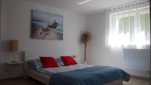 ブワディスワボボにあるStudio 2-pokojowe Magdaのベッドルーム1室(赤い枕のベッド1台付)