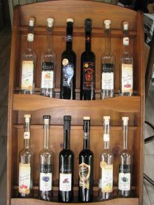 a bunch of bottles of wine on a shelf at Aranyszarvas-Goldener Hirsch Pension in Zalakaros