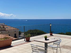 a table and chairs on a balcony with the ocean at Rooms B&B Albergo Riviera in Maiori