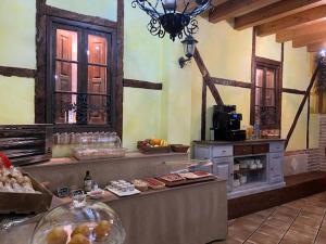 a kitchen with a counter with food on it at Hotel Rural El Marqués in Saldaña