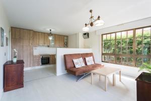 a living room with a couch and a table at Housingcoruña Apartamento Playa Miño 01 in Miño