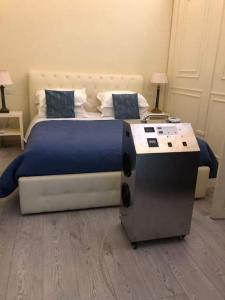 a bedroom with a large bed with a blue comforter at Residenza d'Epoca Palazzo Riblet in Florence