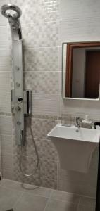 a bathroom with a shower and a sink at Draga Apartment in Nesebar