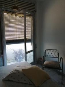 a bedroom with a bed and a large window at Can Ventura in Deltebre