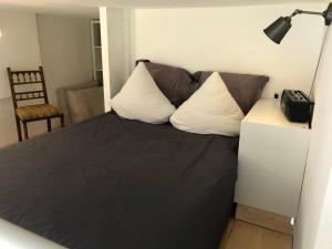 a bedroom with a bed with two pillows on it at Loft mon Soleil in Le Hohwald