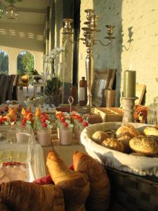 a table with bread and pastries on it at B&B Amuse-Couche in Hasselt +10 photos