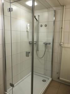 a shower with a glass door in a bathroom at Hotel Schwanen Wil in Wil