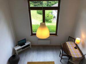 a living room with a table and a large window at Loft mon Soleil in Le Hohwald