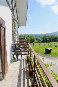 a porch with benches and a view of a field at Caserio en Zona Rural Istilla in Hondarribia