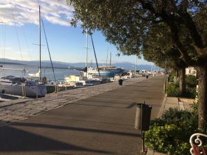 a row of boats docked on a street next to the water at Apartments Toni-Malinska in Malinska