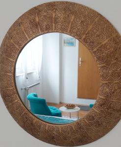 um espelho num quarto com uma cadeira azul em Adria Apartments and Rooms em Dubrovnik