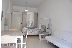 a living room with a couch and a bed at la casa di Marco in Canosa di Puglia
