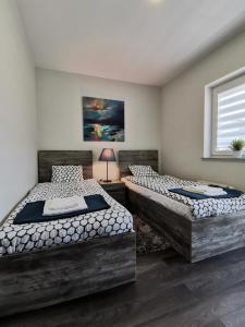 Ένα ή περισσότερα κρεβάτια σε δωμάτιο στο Apartamenty Portowy
