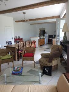 a living room with a couch and a table at le Logis du Plessis in Chaniers