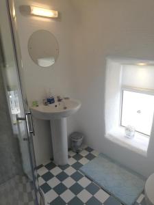 a bathroom with a sink and a mirror at The Barn @Ardhill House in Ardara