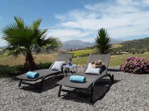 a pair of chairs with a hat sitting on them at Casa al Cerro in Alora