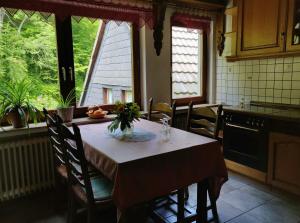 a kitchen with a table with a vase of flowers on it at Zur alten Schmiede in Iserlohn