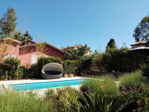 a backyard with a swimming pool and a house at House Giovanni in Premantura