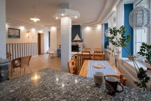 a kitchen and living room with a table and chairs at Koga in Ustka