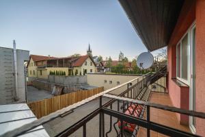 a balcony with a view of a city at Penzión & Bar NATALI in Spišský Štvrtok