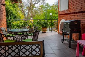a patio with a grill and a table and chairs at Koga in Ustka