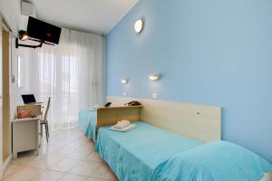 Postel nebo postele na pokoji v ubytování Hotel Sant'Angelo