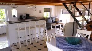 a kitchen and living room with a counter top at Refugium im Nordseewind in Norddeich