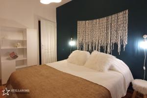 een slaapkamer met een groot bed met witte kussens bij StellaHome - Sur Les Toits in Sanary-sur-Mer