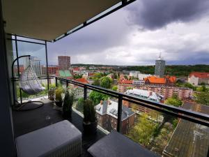 a balcony with a view of a city at Walowa Tower Apartments in Gdańsk