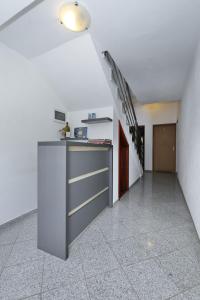 an empty room with a counter and a staircase at Villa Rajna in Starigrad