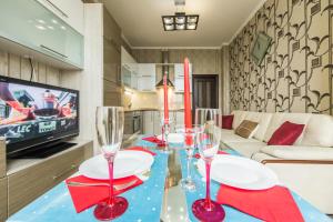 a dining room with a table with wine glasses on it at Rent-Kiev 2 min metro Chernihivska Lux in Kyiv