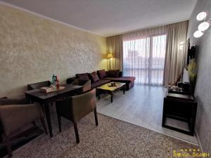 a living room with a couch and a table at ROYAL BEACH HOTEL apartment in Sunny Beach +75 photos