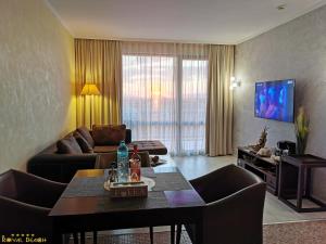 a living room with a couch and a table at ROYAL BEACH HOTEL apartment in Sunny Beach
