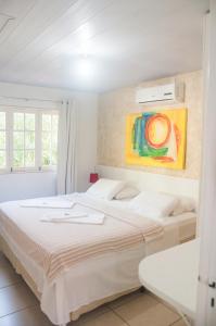 Ένα ή περισσότερα κρεβάτια σε δωμάτιο στο La Dolce Vita Flat & Pousada