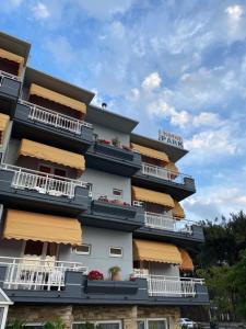 a tall building with balconies and flowers on it at Park Hotel in Alexandroupoli