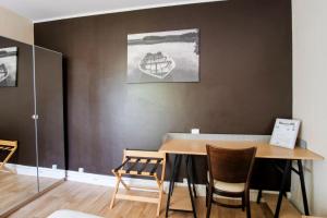 a dining room with a wooden table and chairs at Les Gués Rivières in Pujols Gironde