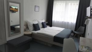 Postel nebo postele na pokoji v ubytování Hotel Metropol CB