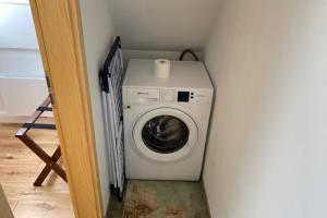 a washer and dryer in a corner of a room at Cottage@Baltic-Chalets in Kalkhorst