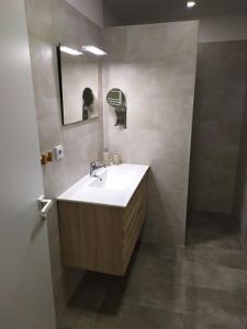 a bathroom with a sink and a mirror at Apartmánový dům Malá Morávka in Malá Morávka