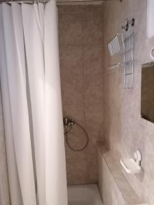 a bathroom with a shower with a white shower curtain at Jasmin in Laichingen